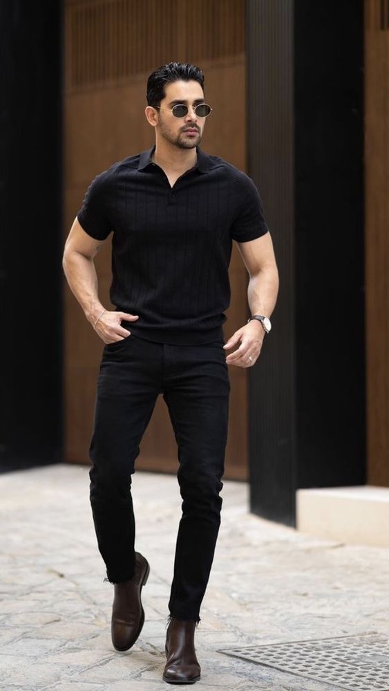 Black polo shirt paired with black jeans and brown Chelsea boots